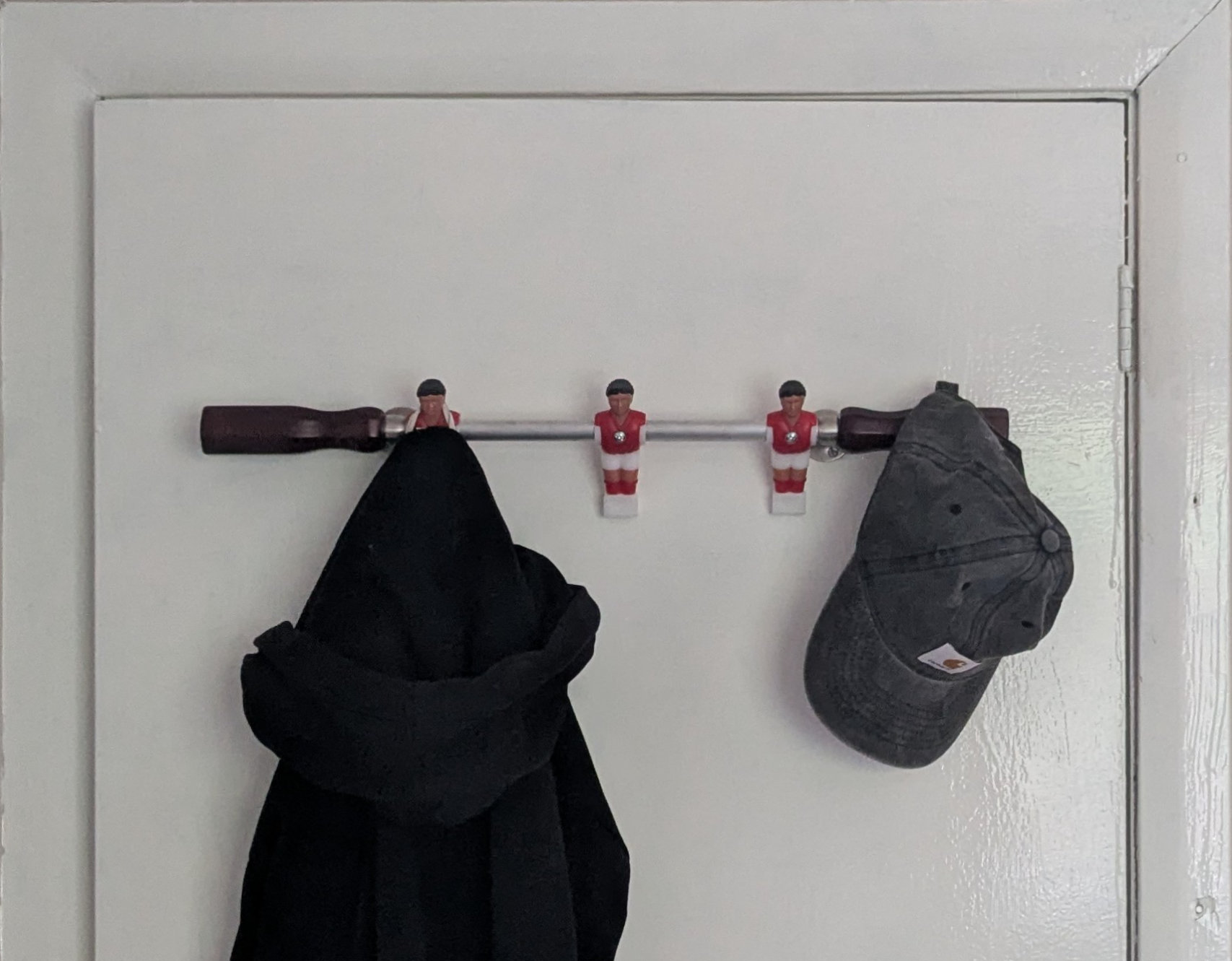 Table football coat hooks mounted on a door